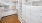 a closet with cabinets, shelves and hangers