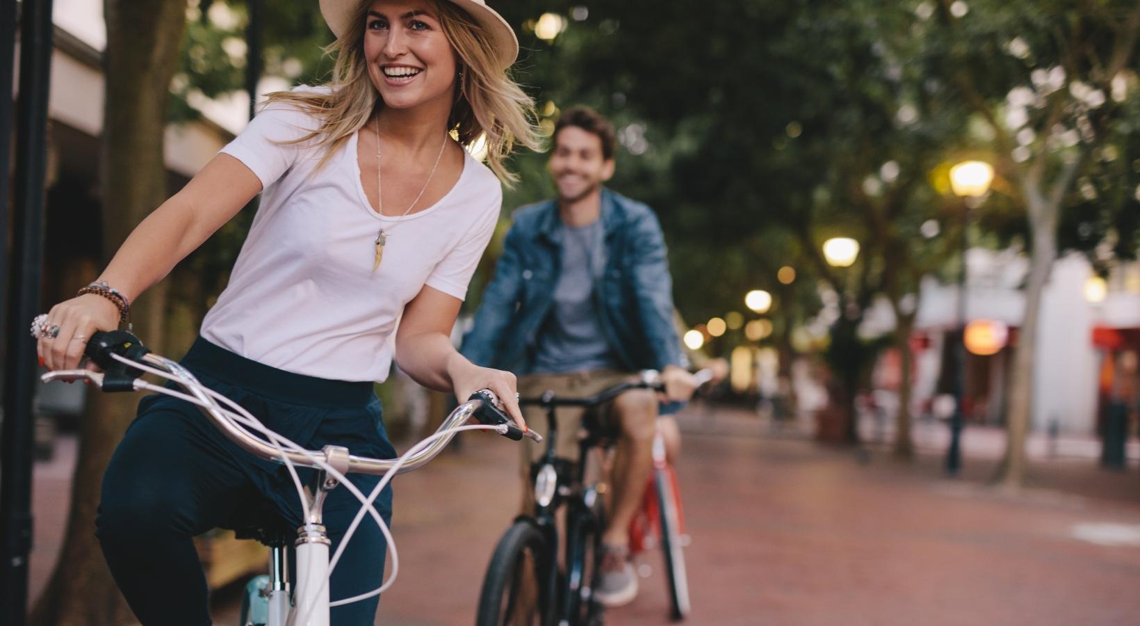 A beautiful community at the heart of all your passions a woman and a man riding a bicycle