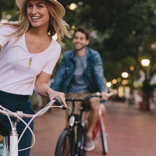 A beautiful community at the heart of all your passions a woman and a man riding a bicycle