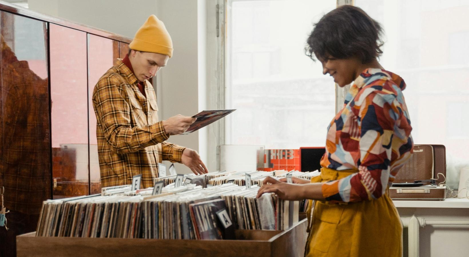 Find your perfect fit at Honeyman Hardware Lofts a man and a woman looking at vinyls