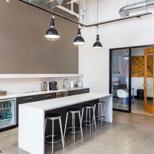 Vibrant community life with a variety of dining options a kitchen with stools and a bar