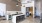 a kitchen with stools and a bar