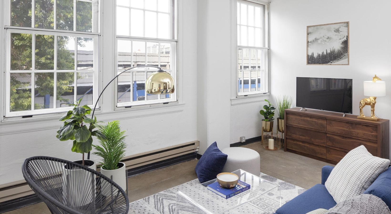 Relax and unwind in well-lit living areas a living room with a large window