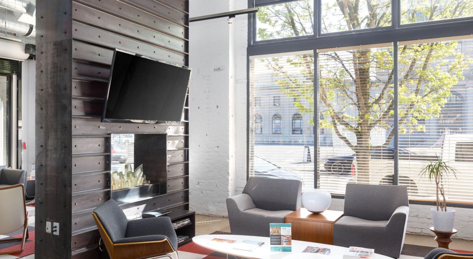 Quick access to state-of-the-art amenities a clubhouse room with a tv, chairs and a table