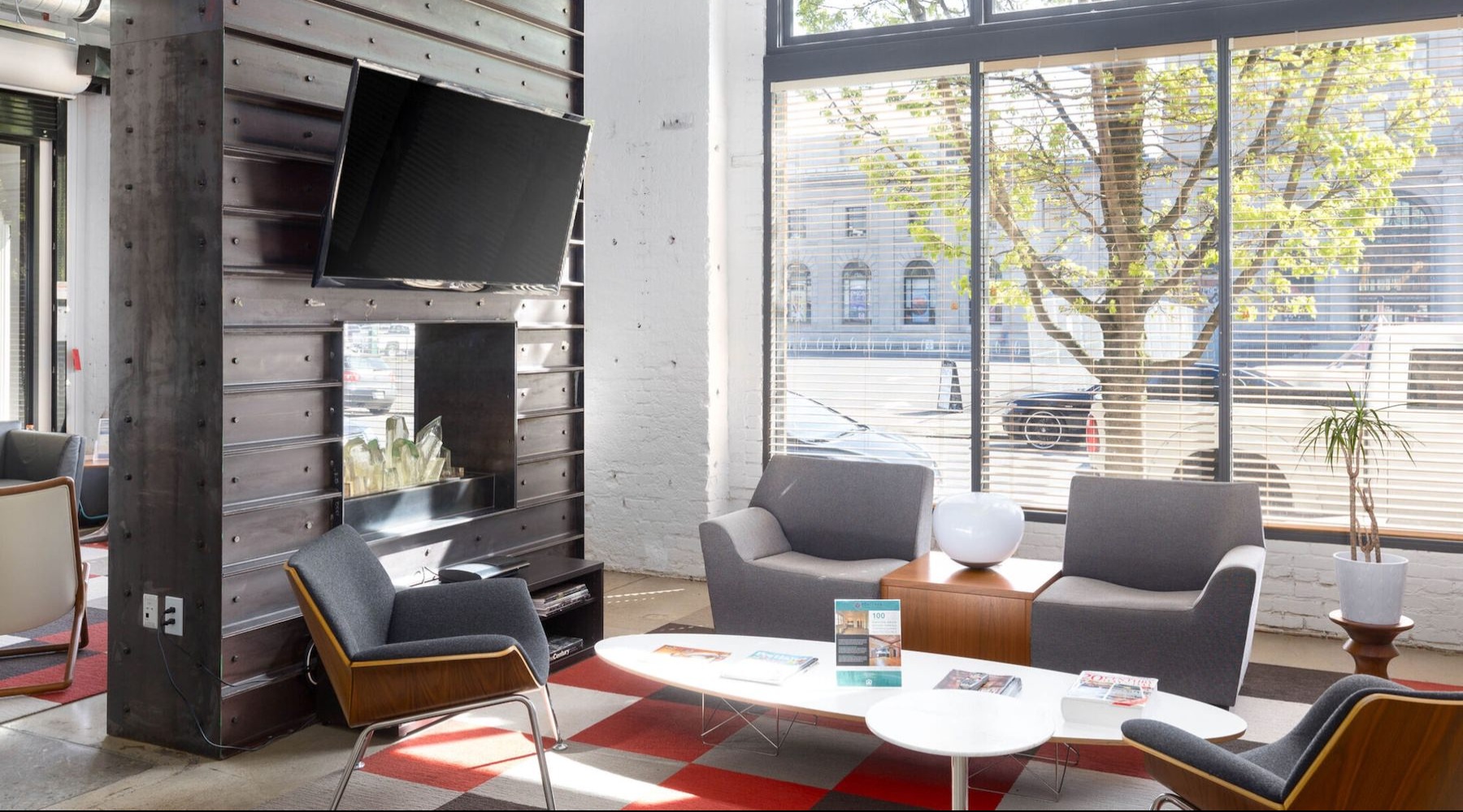 Access to resident-only features a clubhouse room with a tv, chairs and a large window