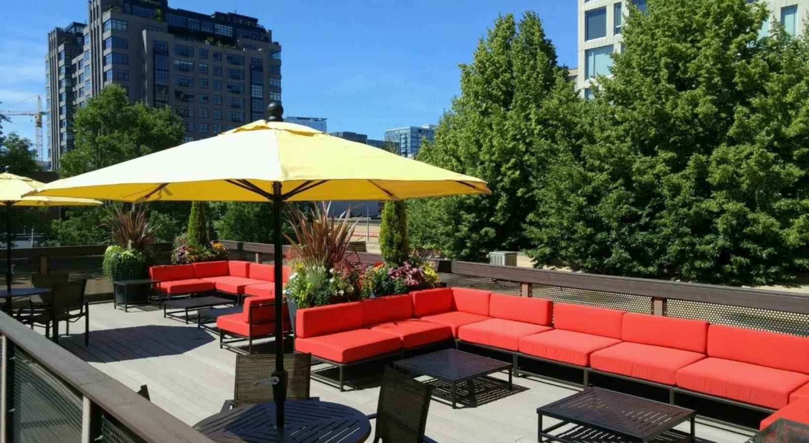 Access to resident-only features a patio with tables and chairs and umbrellas