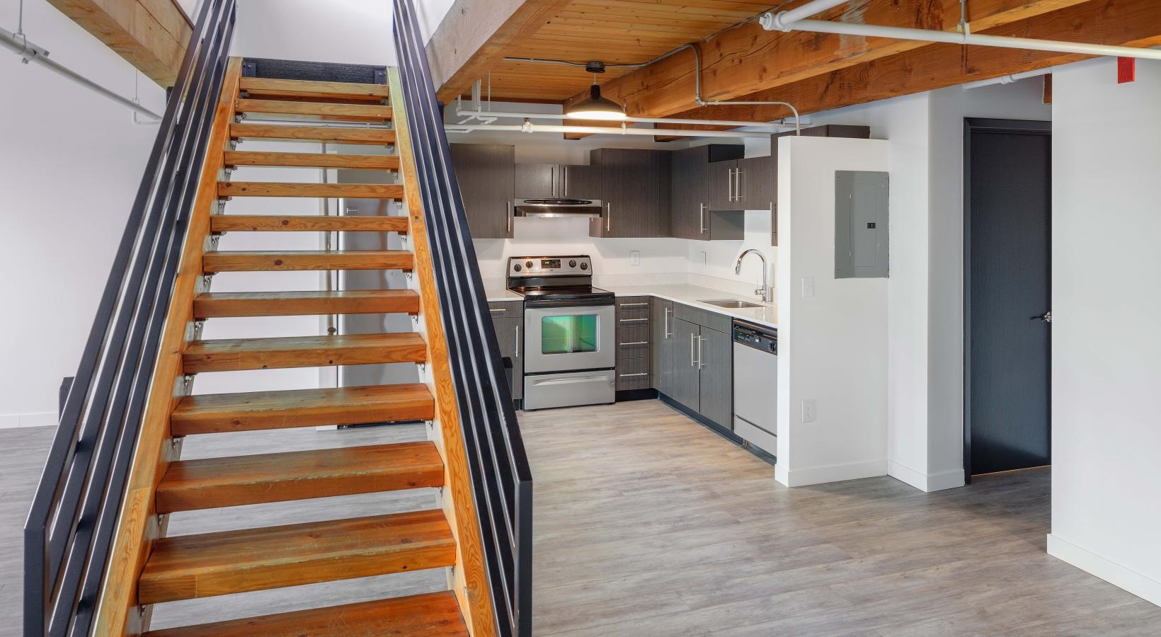 Beautiful kitchens with designer finishes a kitchen with a staircase leading upstairs