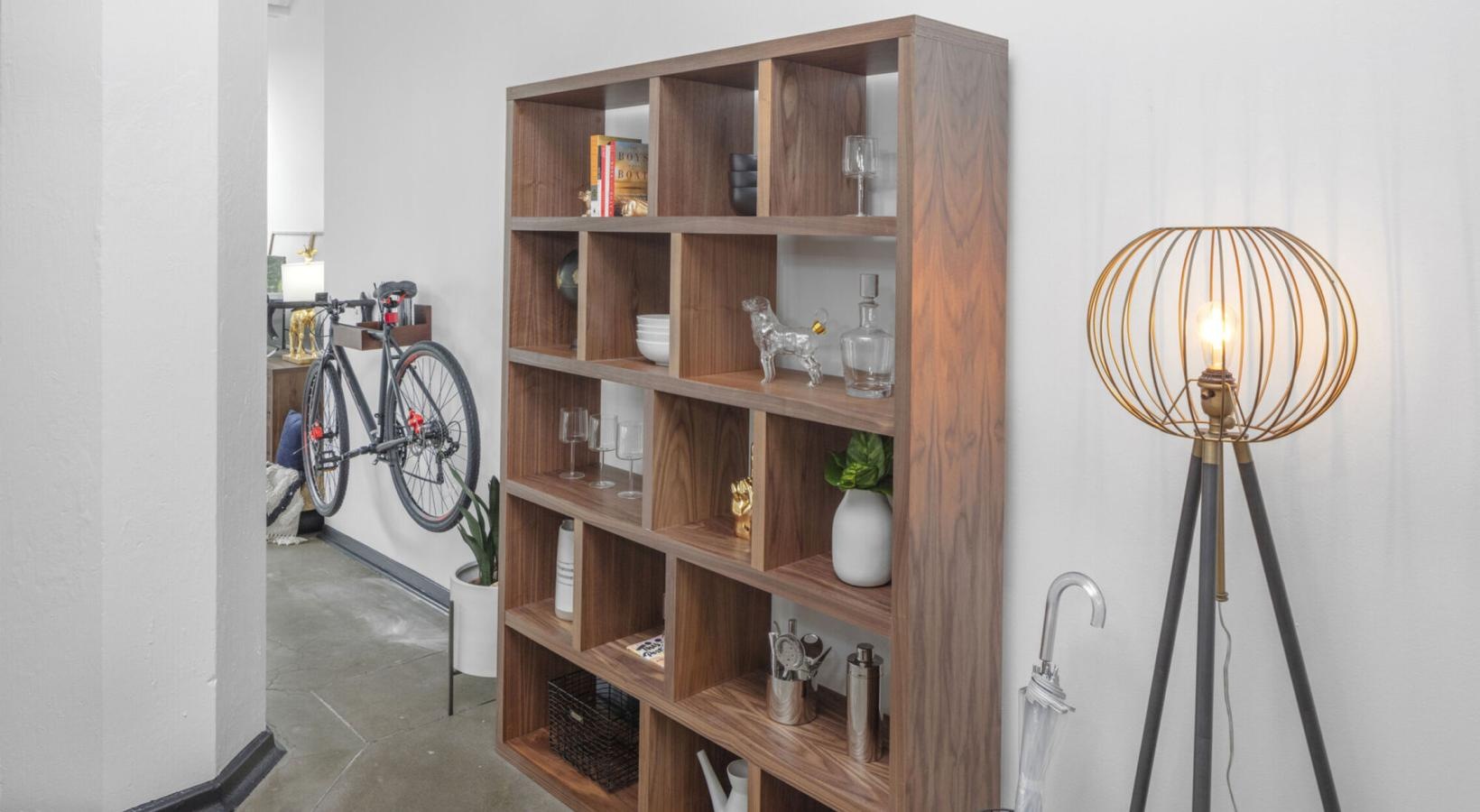 Gorgeous living areas to entertain and enjoy a room with a shelf and a lamp