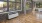 a room with wood floors and brick wall