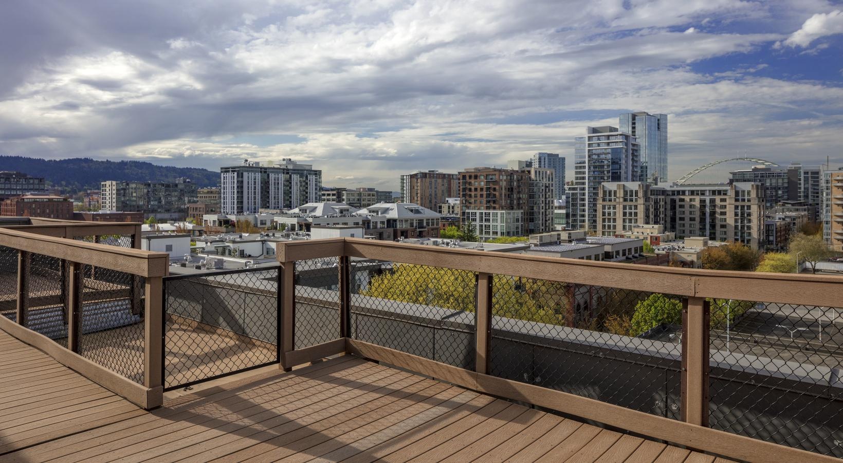 Find your perfect fit at Honeyman Hardware Lofts a wooden deck overlooking a city