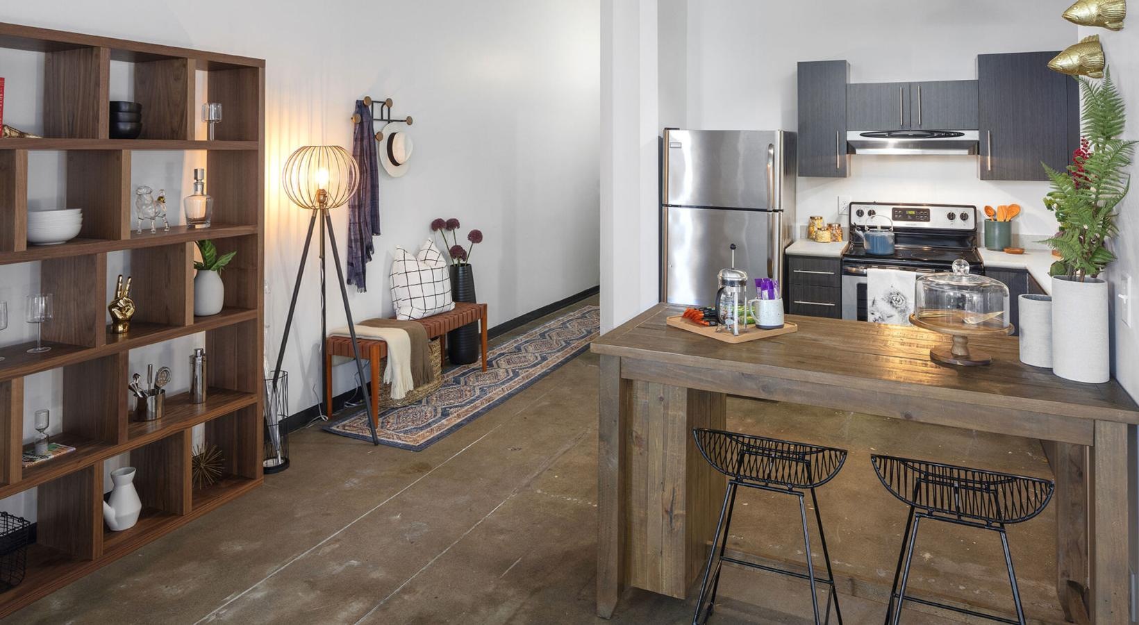 Spacious kitchens with thoughtful details a kitchen with a bar and stools