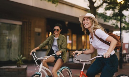 two women riding bikes