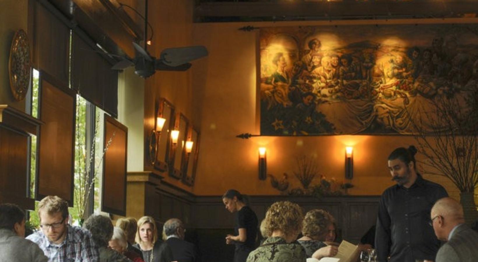 Close to the center of everything a group of people sitting at tables in a restaurant