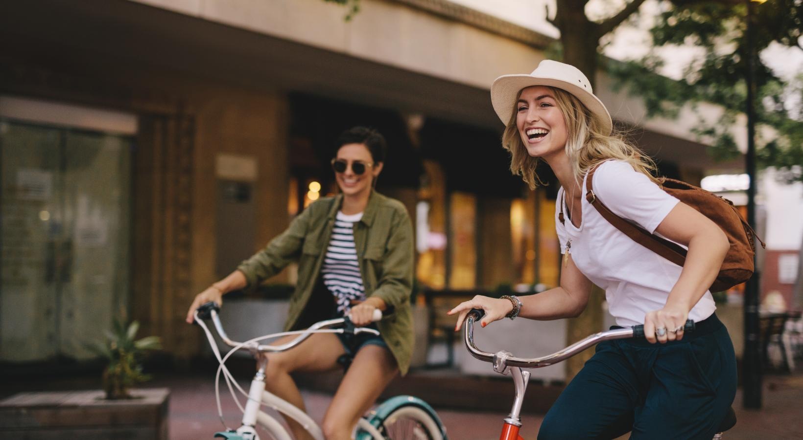 Close to the center of everything two women riding bikes